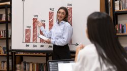 peron-doing-presentation-her-colleagues